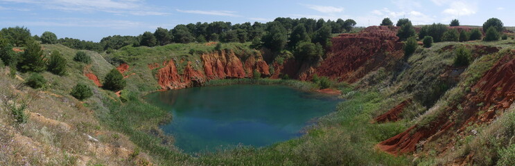 Otranto Bauxite Pond is an abandoned mining quarry for the extraction of bauxite. The presence of a water table, encountered during the excavation phase, caused the formation of a small pond.