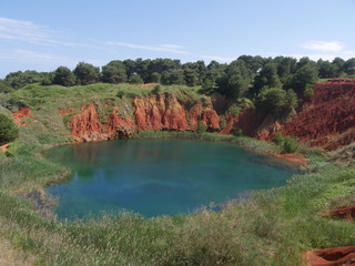 Otranto Bauxite Pond is an abandoned mining quarry for the extraction of bauxite. The presence of a water table, encountered during the excavation phase, caused the formation of a small pond.