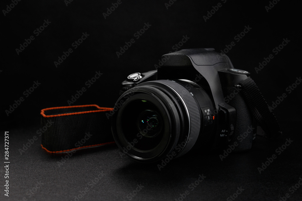 Wall mural professional digital slr camera on black background