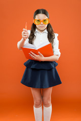 inspiration for writing. get information from book. happy school girl in uniform and party glasses. small child with notebook. literature lesson education. writing in workbook. children literature