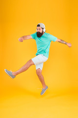 Bearded guy enjoy music. Music fan. Man listen music wireless headphones in motion. Impetuous movement. Hipster dancing jumping headphones gadget. Inspiring song. Music library. Energy of rhythm