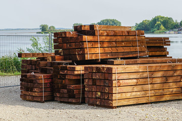 a stack of impregnated timber ready for the construction of a wooden house