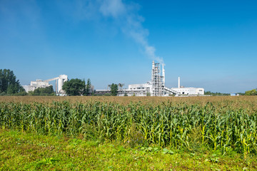 Industrial landscape environmental pollution waste of cement factory. Big pipes of industry enterprise plant. lime and chalk coated factory pipes