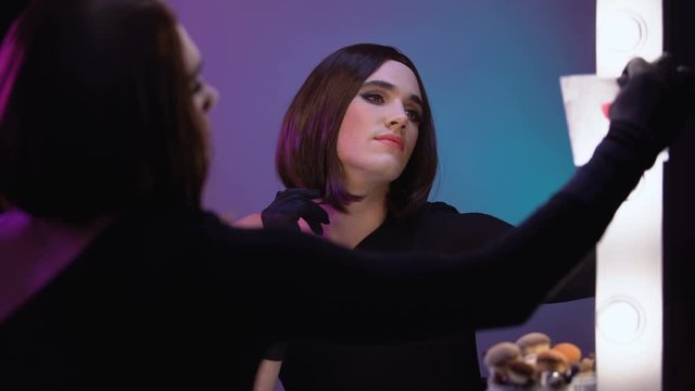 Travesty diva taking love note from mirror, enjoying free transgender relations