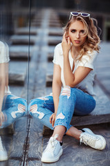 Fashion portrait of a young woman with white sunglasses