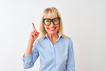 Middle age businesswoman wearing sunglasses and shirt over isolated white background surprised with an idea or question pointing finger with happy face, number one