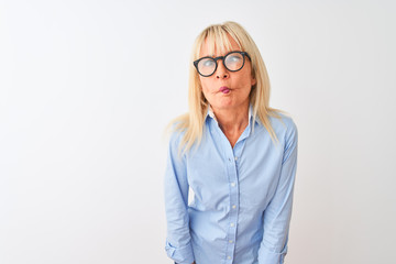 Middle age businesswoman wearing elegant shirt and glasses over isolated white background making fish face with lips, crazy and comical gesture. Funny expression.