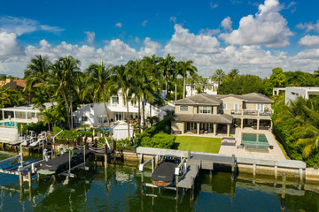 Luxury Miami Beach waterfront house with boat and palm trees
