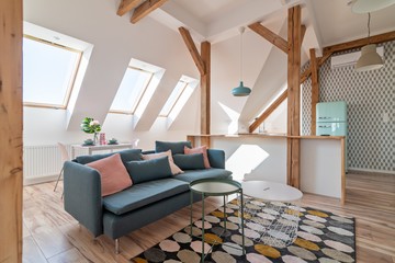 attic living room with textile sofa and coffee table