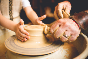 Professional potter making bowl in pottery workshop, studio.