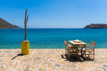 Empty table in the sea shore tavern, Crete, Greece 