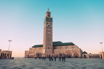 Fototapeta na wymiar tourists walking and taking pictures at Hassan II mosque's square