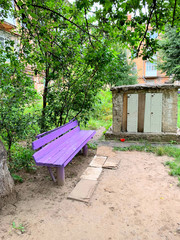 An old bench in the courtyard is purple.