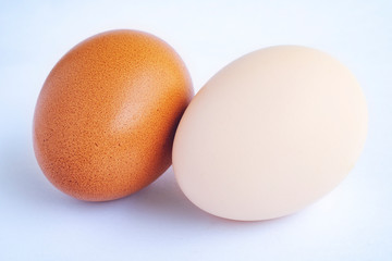 Macro view of brown and white eggs on the white background