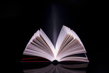 Book with glowing light coming from inside of it. High resolution image.