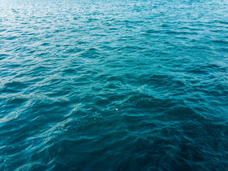 Sea water with small waves on a summer sunny day. Background image.