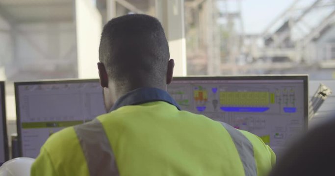 Black industrial worker working on computer
