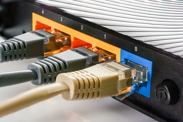 Home internet router with three cables with rj-45 connectors, internet connection. Concept home...