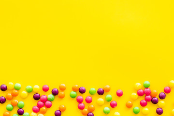 Candies for party design on yellow background top view copyspace