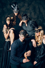 Group of people in masquerade carnival mask posing in studio - obrazy, fototapety, plakaty