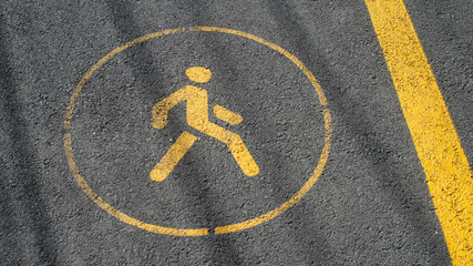 Road sign WALK yellow markup paint bicycle path asphalt texture