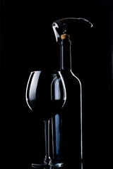 A bottle of wine. Wine glass. Natural cork. Metal corkscrew.