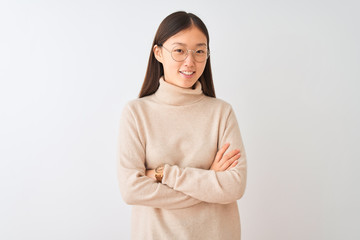 Young chinese woman wearing turtleneck sweater and glasses over isolated white background happy face smiling with crossed arms looking at the camera. Positive person.