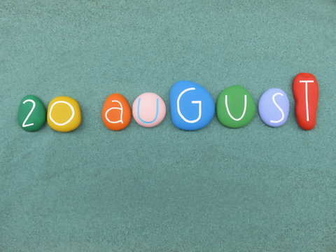 20 August, calendar date composed with multi colored stones over green sand