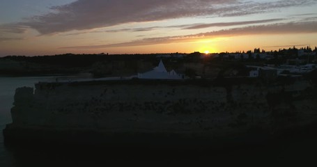 Sunset aerial view on Praia da Senhora da Rocha in the south coast of Algarve destination region, Portugal.