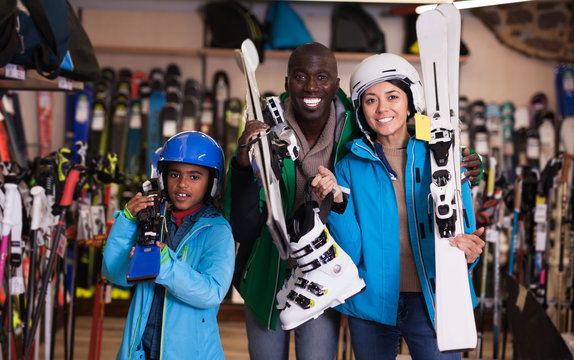 Multiracial Family Posing In Skiing Gear