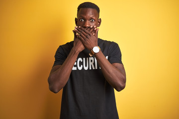 African american safeguard man wearing security uniform over isolated yellow background shocked...