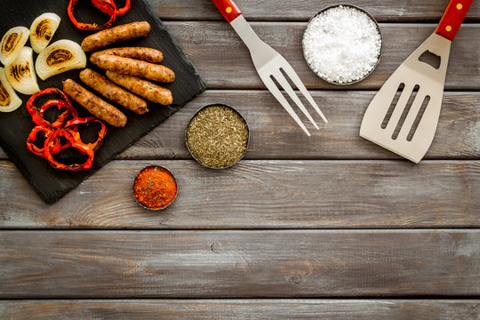 Barbecue, Sausages, Vegetables And Kitchen Tools On Wooden Background Top View Mock Up