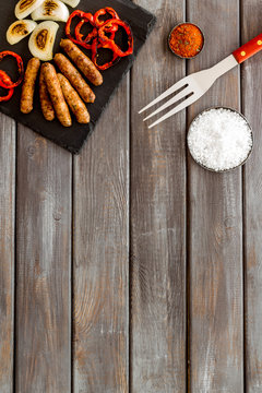 Barbecue, Sausages, Vegetables And Kitchen Tools On Wooden Background Top View Mock Up