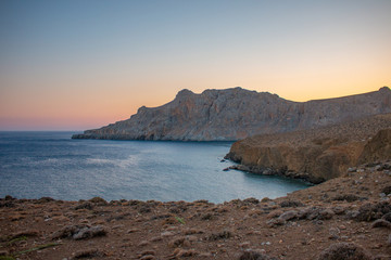 Tripiti beach east Crete on sunset. Trafoulas mountain near to Lendas, Crete Greece. Beautiful landscape sea and mountains on sunset.
