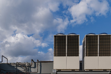 Fototapeta premium Heating and Cooling System of air Air Conditioning System set up on rooftop of building against blue sky.
