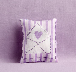Purple striped cushion with love letter decoration
