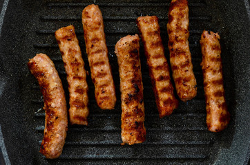 grilled sausages in grill pan. Top view