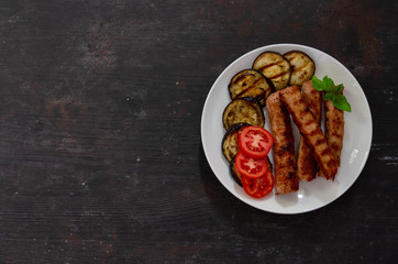 Baked eggplant with sausage, tomatoes. Fan of eggplant. View from above