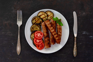 Baked eggplant with sausage, tomatoes. Fan of eggplant. View from above