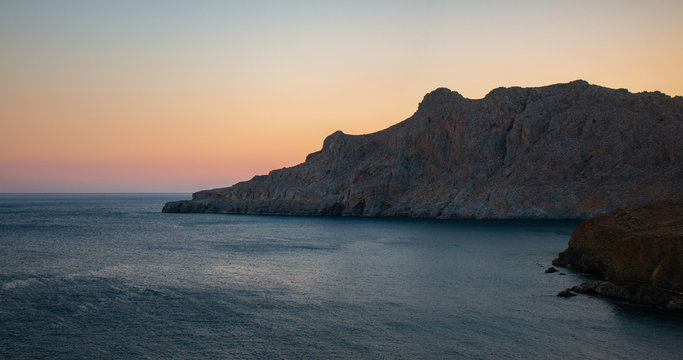 Tripiti beach east Crete on sunset. Trafoulas mountain near to Lendas, Crete Greece. Beautiful landscape sea and mountains on sunset.