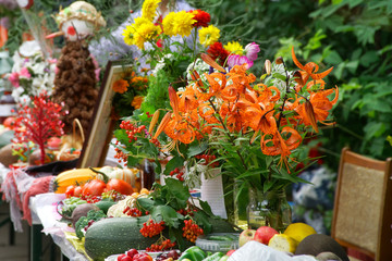 Obraz na płótnie Canvas A delightful bouquet of orange tiger lilies on a farm fair counter