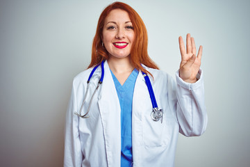 Young redhead doctor woman using stethoscope over white isolated background showing and pointing up with fingers number four while smiling confident and happy.