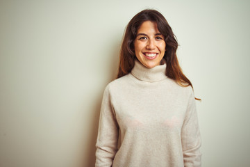 Fototapeta premium Young beautiful woman wearing winter sweater standing over white isolated background with a happy and cool smile on face. Lucky person.