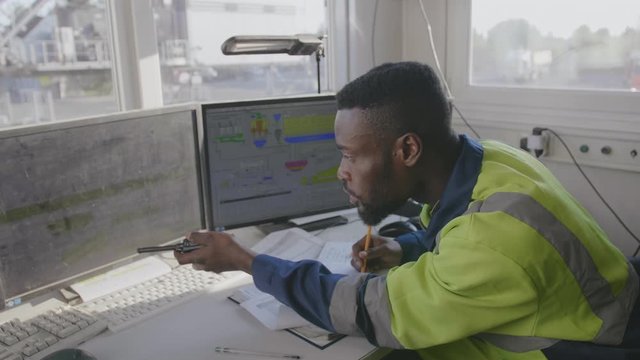 Afro engineer writing report