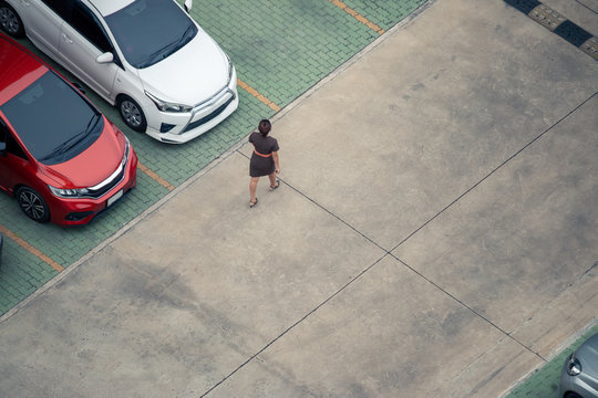 High Angle View Woman Walking In Parking Lot