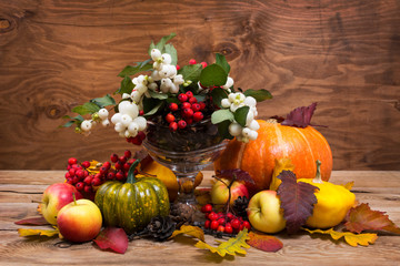 Rustic Thanksgiving centerpiece with snowberry, copy space