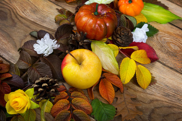 Fall pumpkin, cones, apple and yellow roses