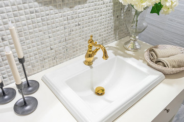 Bathroom luxury classic interior with white sink and classic retro style golden faucet