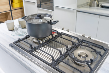 Metal Pot on induction hob in modern kitchen. modern kitchen pot cooking induction electrical stove...