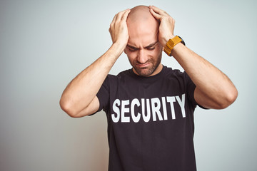 Young safeguard man wearing security uniform over isolated background suffering from headache...